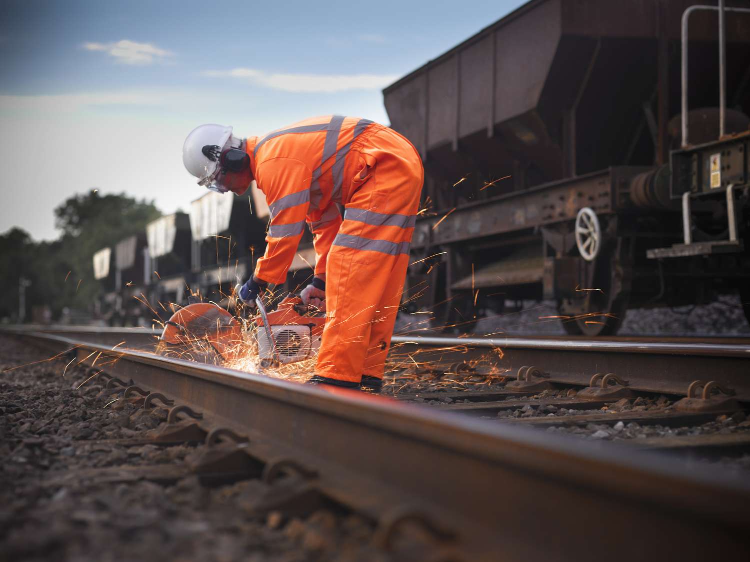 Railroad worker using grinder