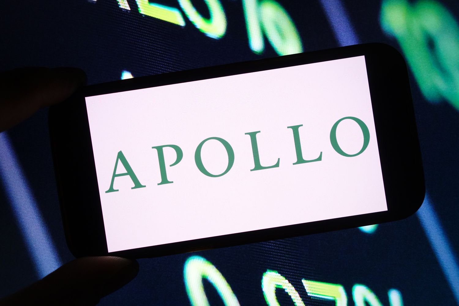 Apollo Global Management company logo is seen displayed on a smartphone screen
