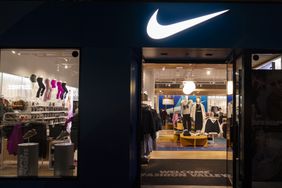 The Nike corporate logo hangs above their store at Fashion Valley in San Diego, California