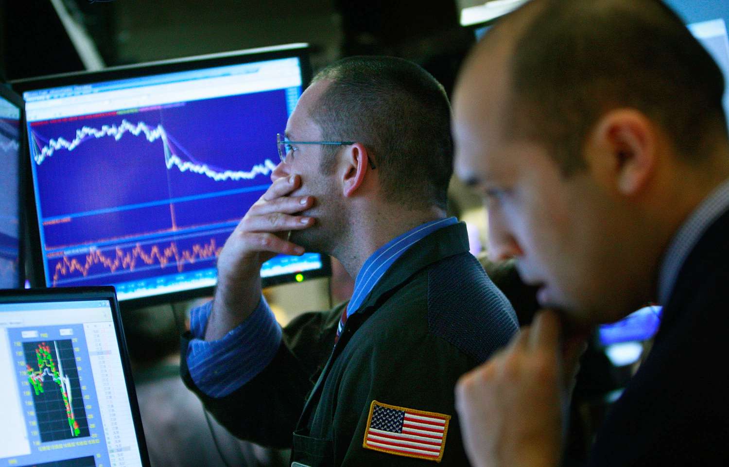  Traders work on the floor of the New York Stock Exchange at the end of the trading day