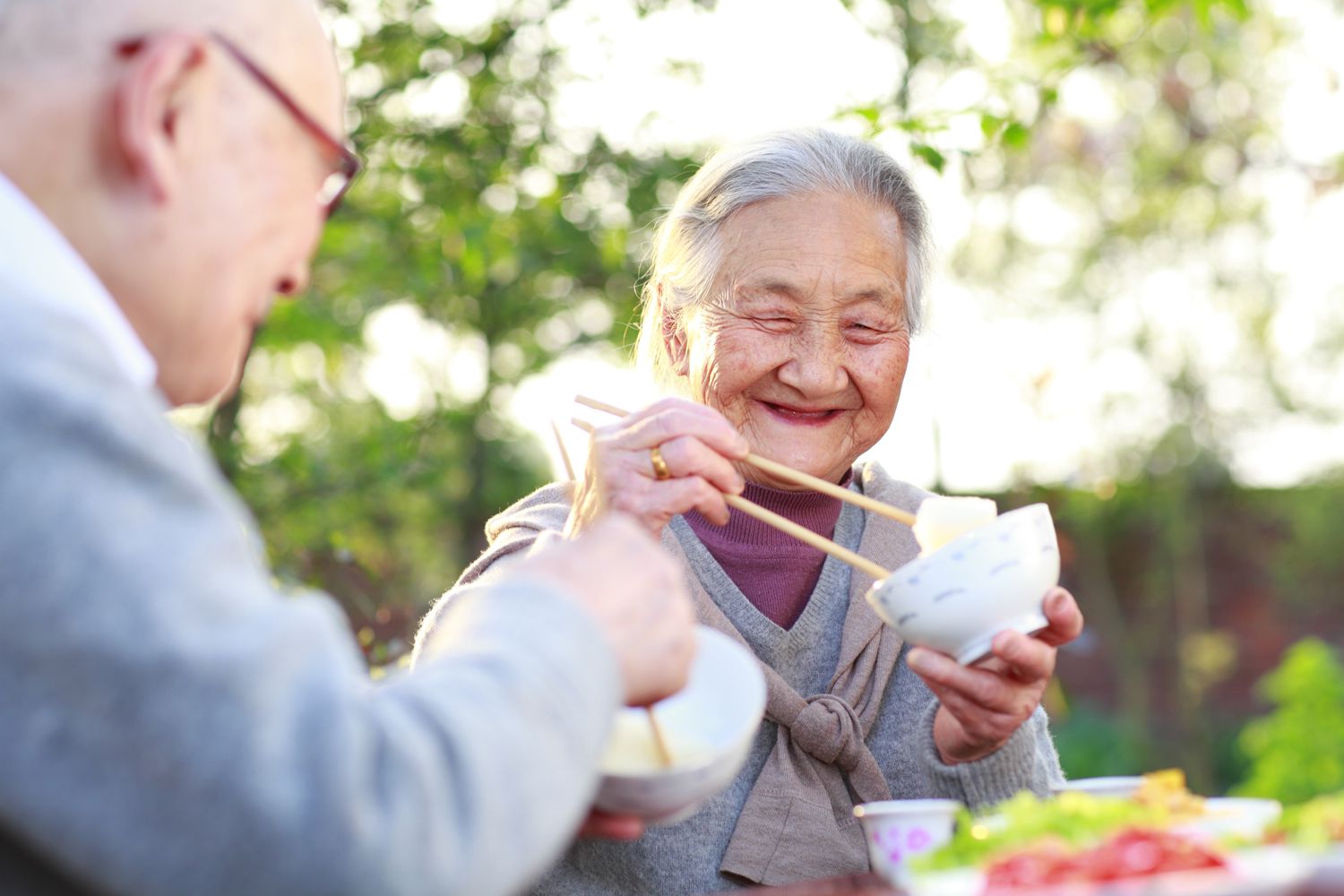 An elderly couple shares a meal.