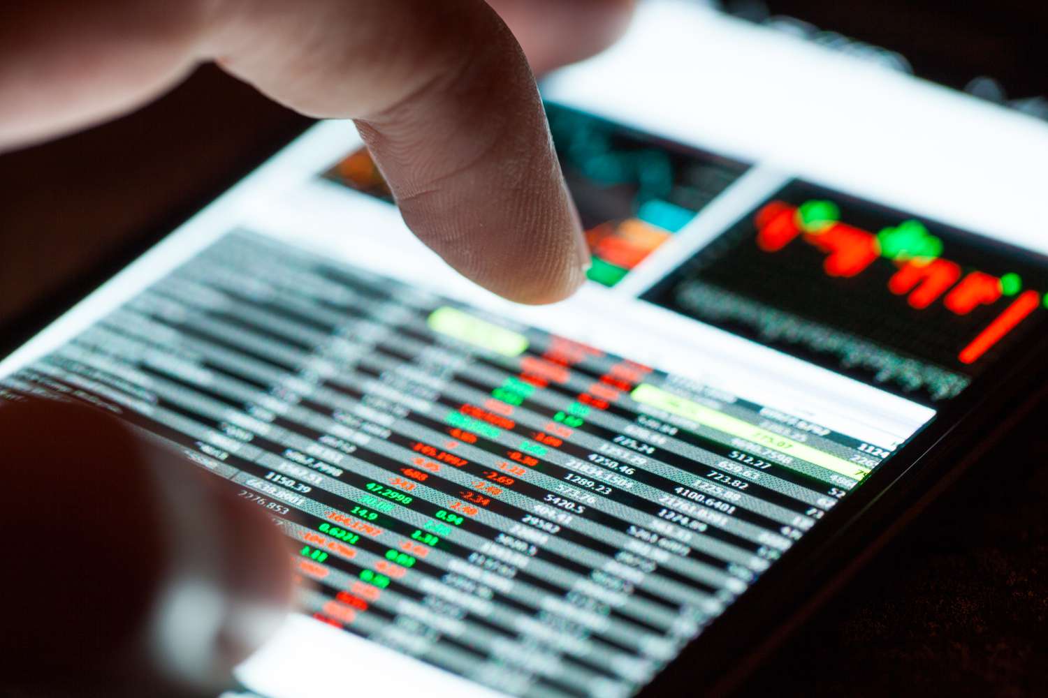 A person using smartphone to check the prices of Nasdaq stocks.
