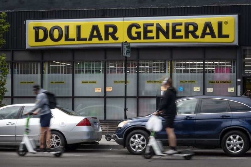 People and cars are seen in front of a Dollar General store in Chicago.