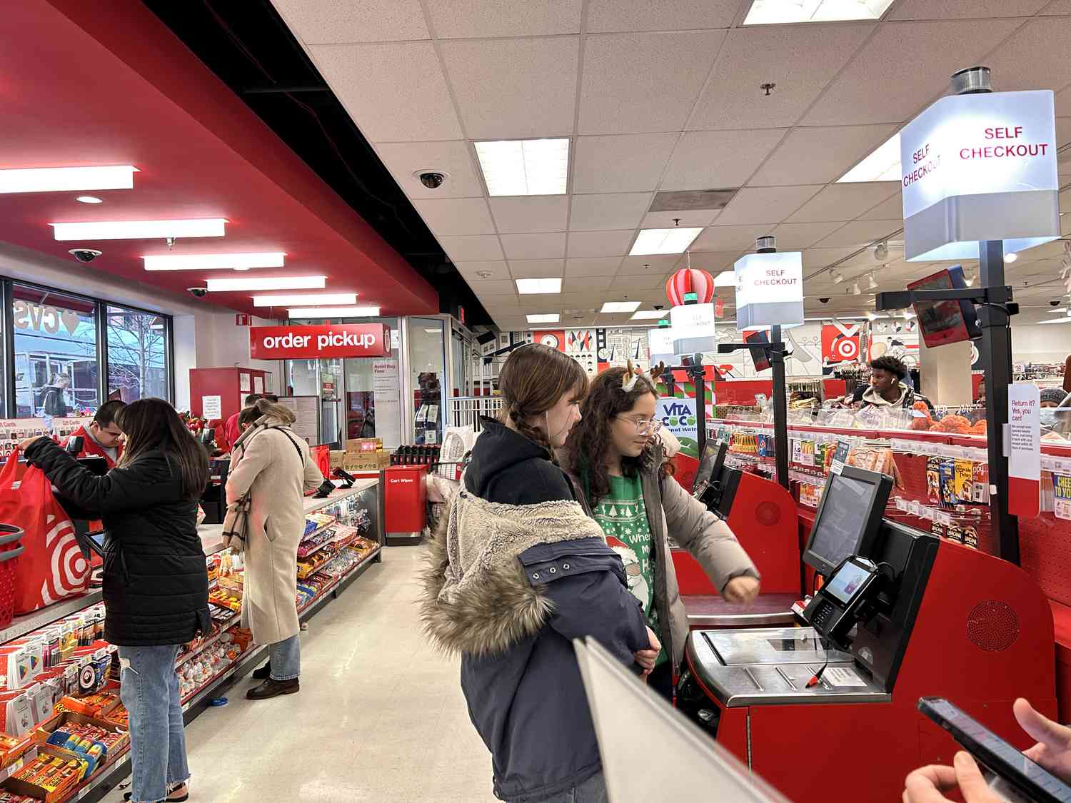 Customers using self check out and regular cashiers at Target store, Queens, New York.