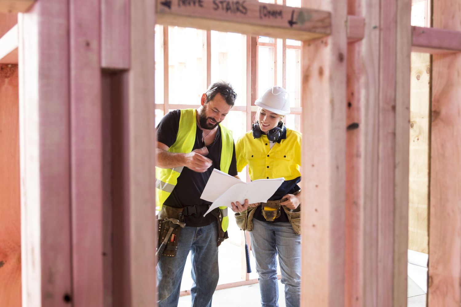 Workers building a home review plans
