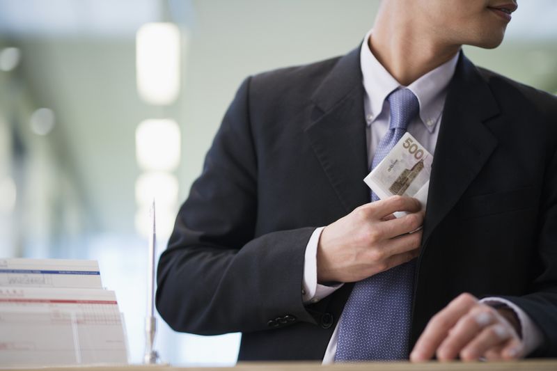 Clerk hiding stolen money in his jacket