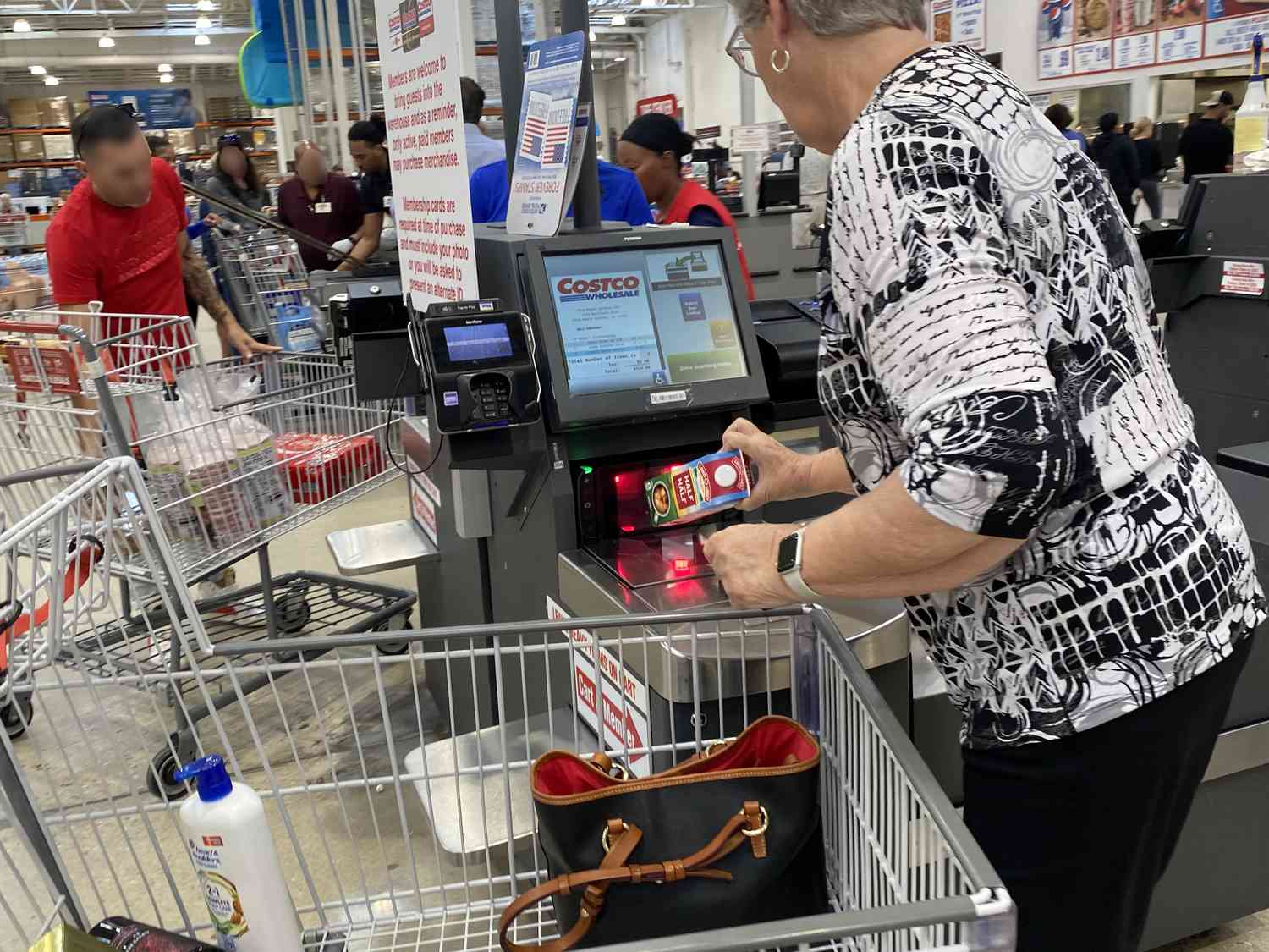 A woman scanning groceries at self checkout line in Costco, Palm Beach, Florida.