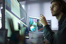 Stock analyst looking at market data