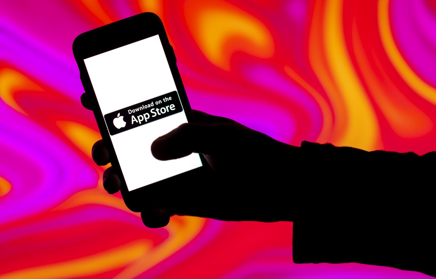 In this photo illustration, an Apple App store logo is seen displayed on a mobile phone screen.