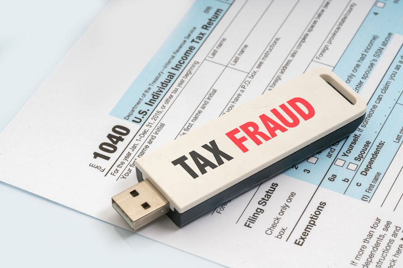 A USB key that says Tax Fraud on a 1040