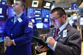 Traders work on the floor of the New York Stock Exchange during morning trading on May 27, 2025 in New York City.
