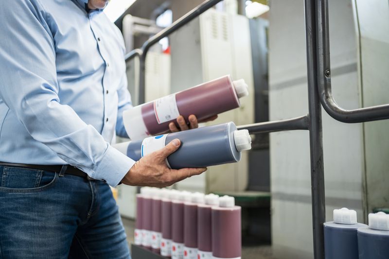 A man compares two types of ink. 