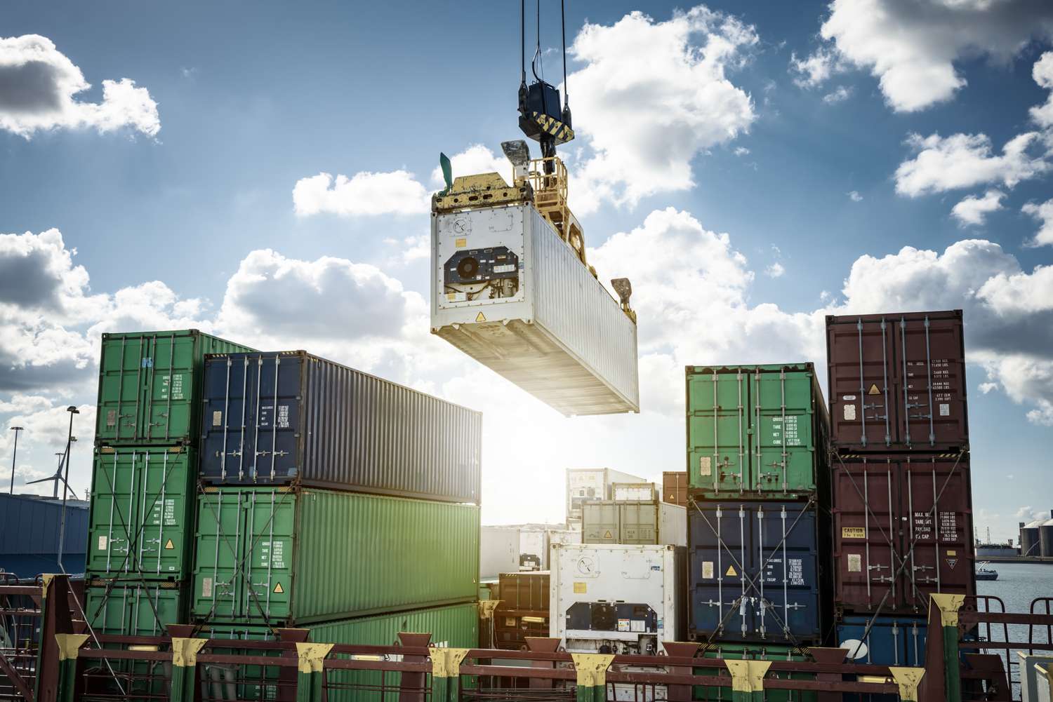 Shipping containers with international goods being unloaded in a port 