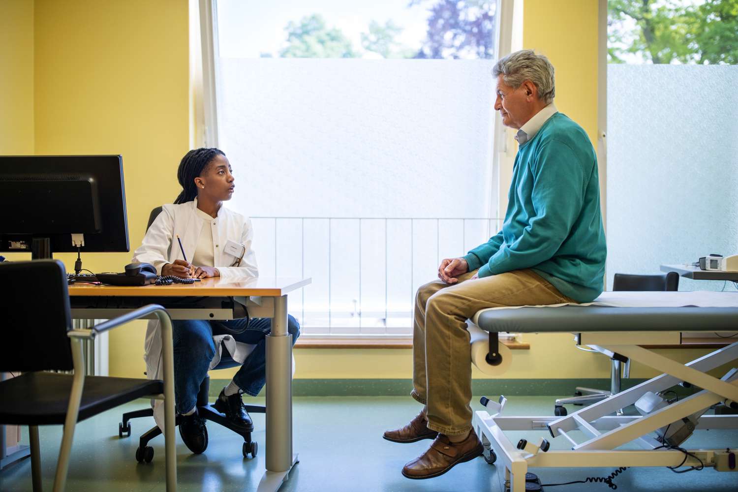Female doctor talking to patient about his condition.