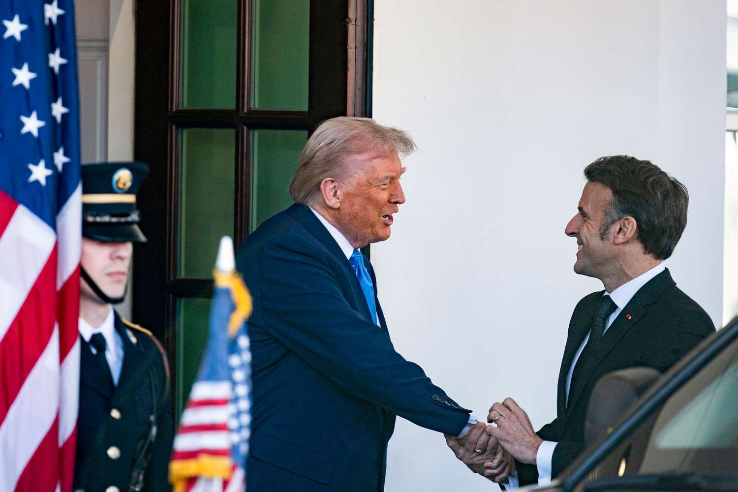 US President Donald Trump, left, and Emmanuel Macron, France's president, shake hands outside the West Wing of the White House in Washington, DC, US, on Monday, Feb. 24,2025.