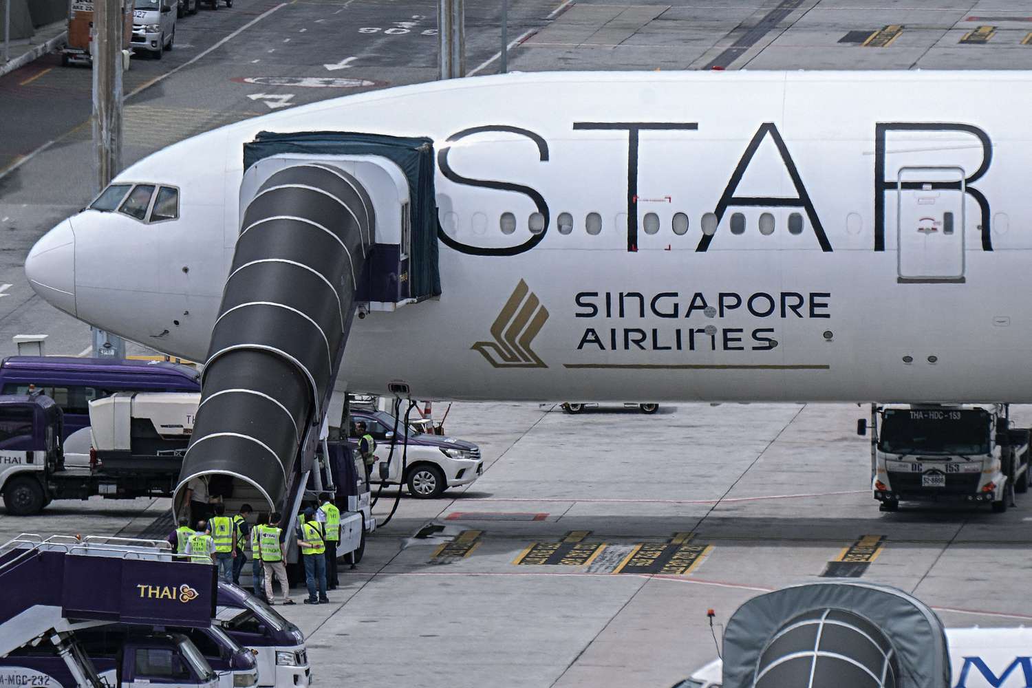 Officials in Bangkok, Thailand, enter the Singapore Airlines Boeing 777-300ER airplane that was headed to Singapore from London before making an emergency landing due to severe turbulence on May 22, 2024