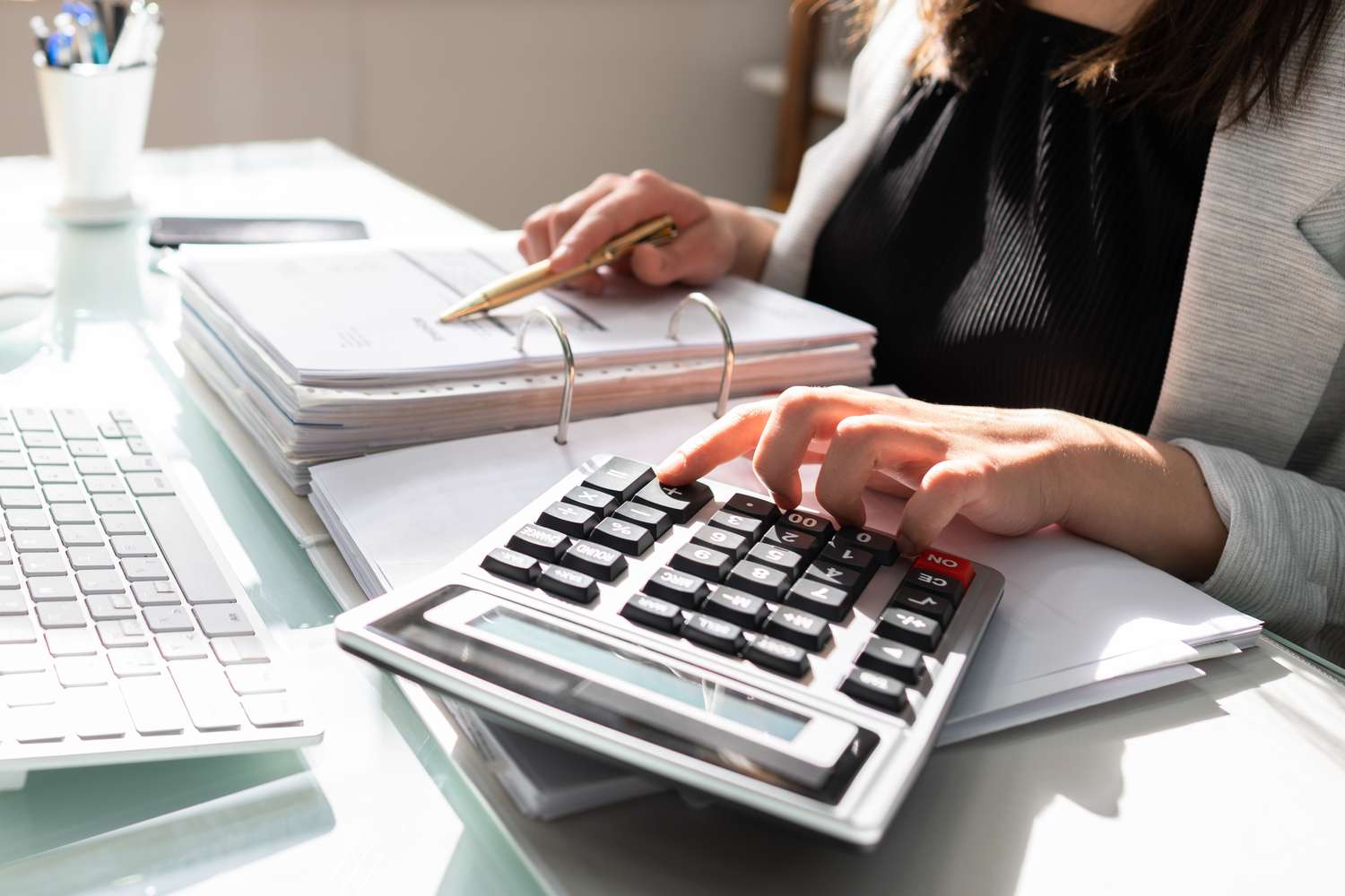 Accountant going over papers with a calculator