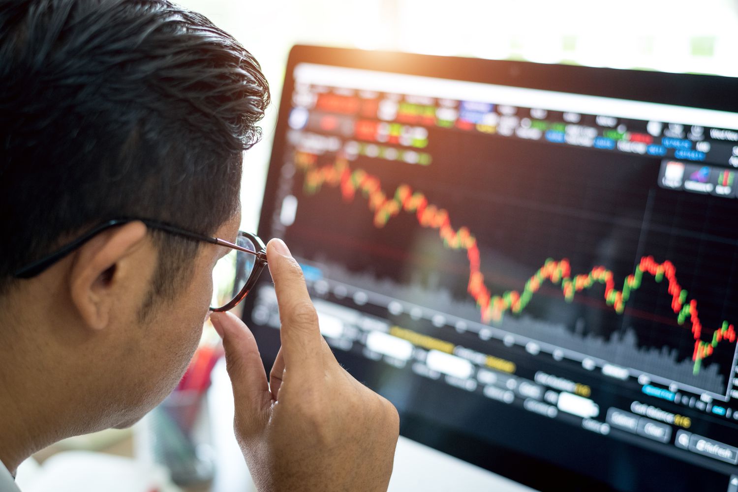 person looking at stock trading screen