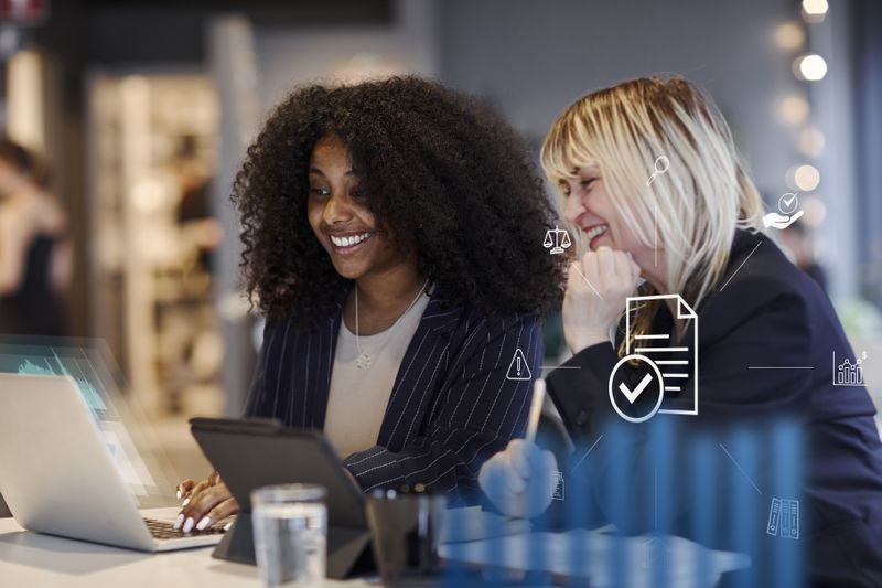 Two people smiles as they look at their ETF returns.
