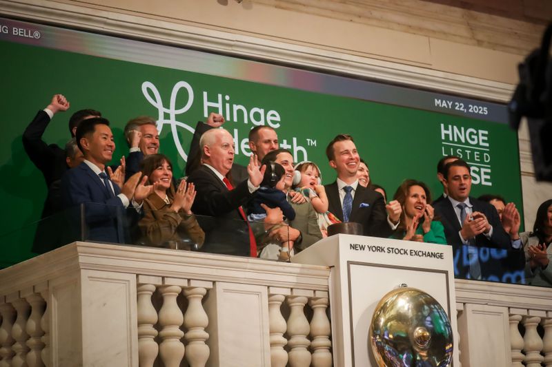 Hinge Health executives ring the opening bell during the company's IPO on Thursday