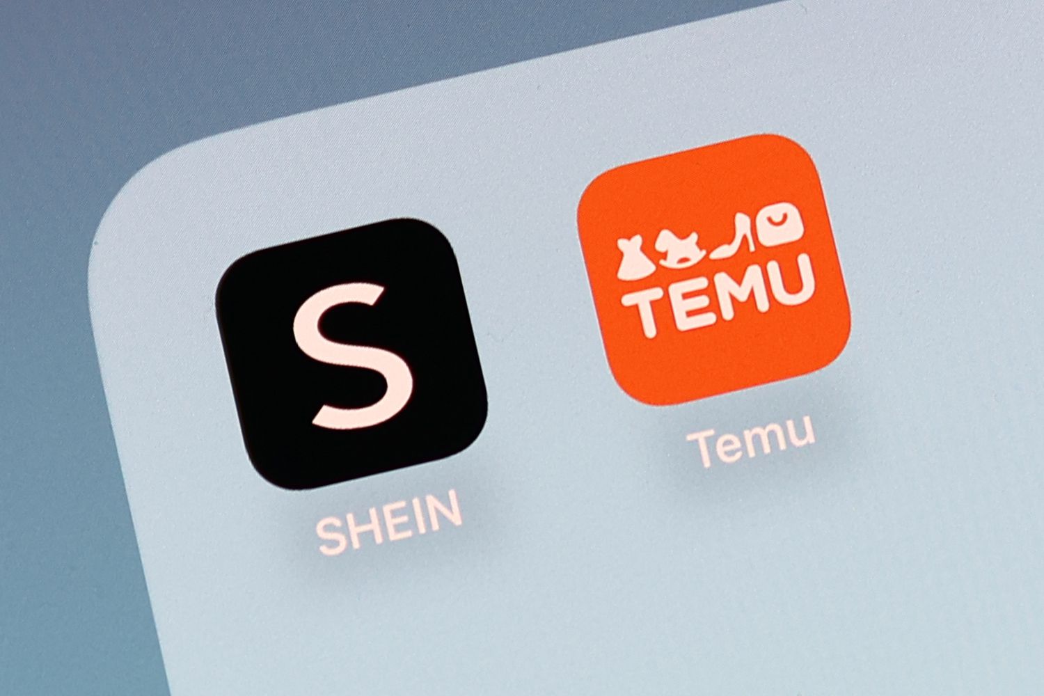 Shein and Temu icons are seen displayed on a phone screen