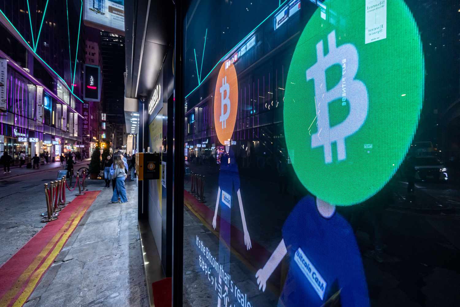 Bitcoin logos on a screen in Hong Kong, China, on Tuesday, Dec. 5, 2023.