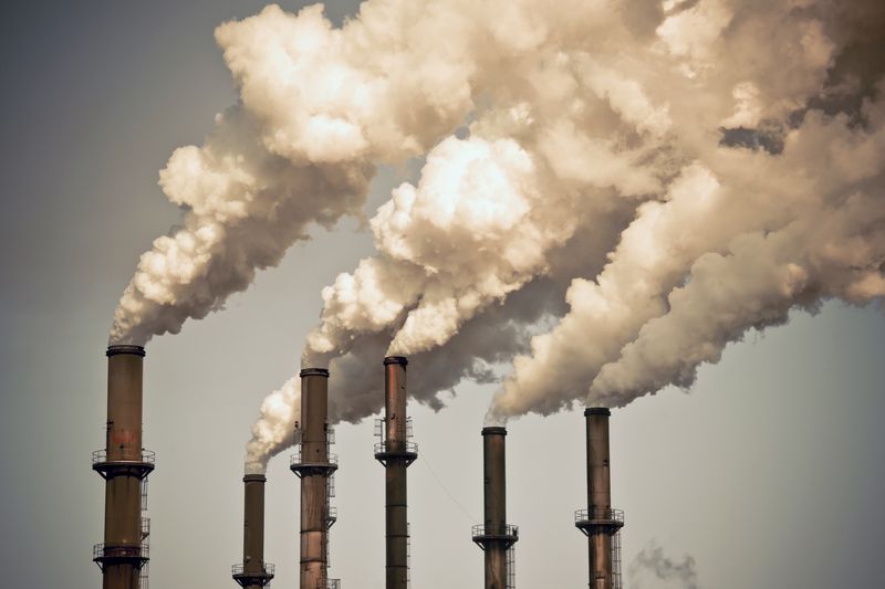 Industrial smokestacks spewing out smoke