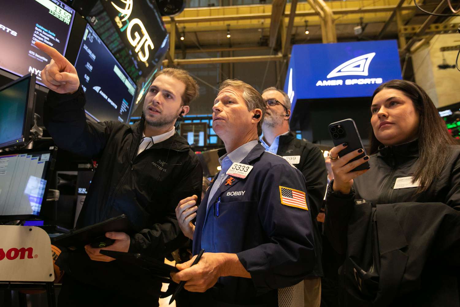 Traders work during Amer Sports Inc.s initial public offering (IPO) on the floor of the New York Stock Exchange.
