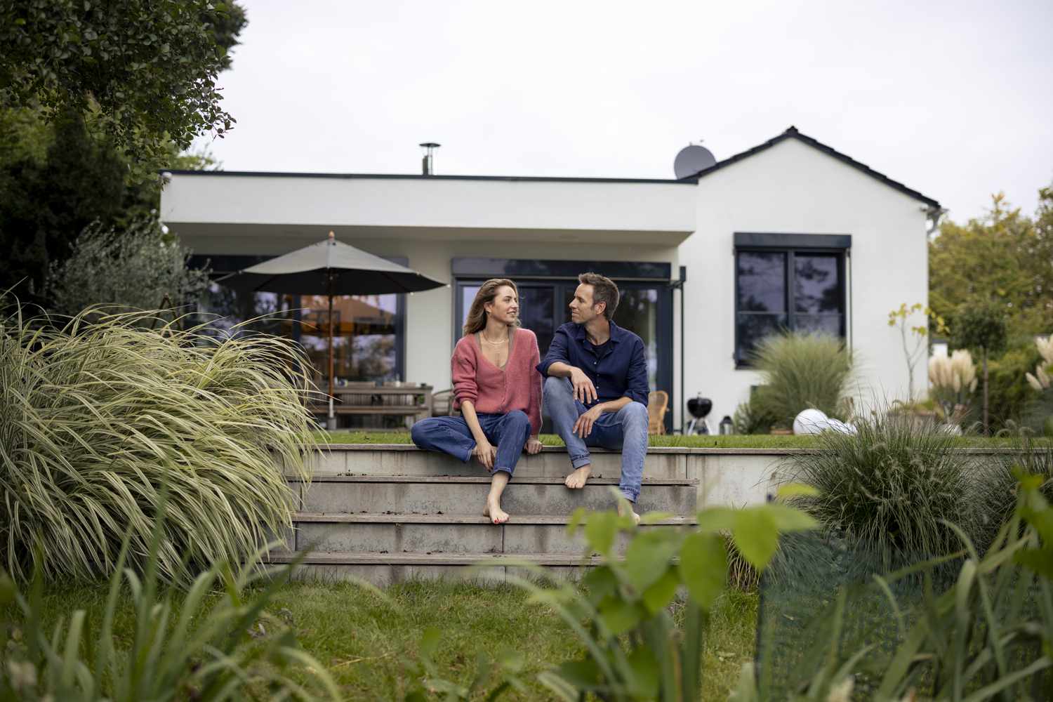 Couple talks on steps in their backyard