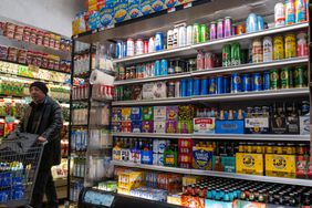 Beer sits in a fridge at a supermarket. 