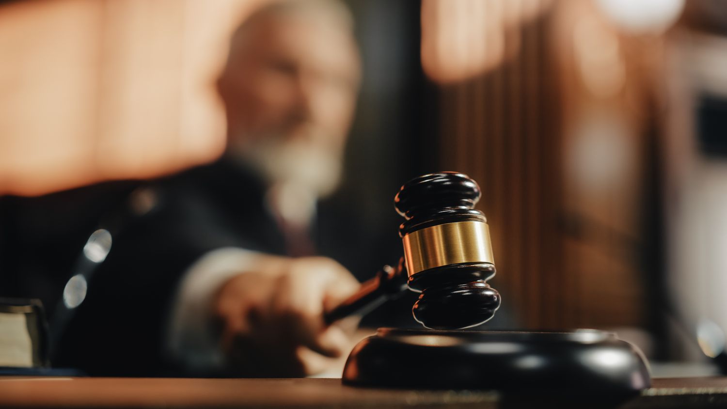 A judge bangs a gavel after making a legal ruling on a case.