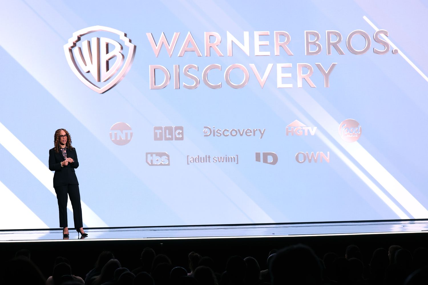 The Warner Bros. Discovery logo is seen on a screen, above the names of the TV channels the company owns.