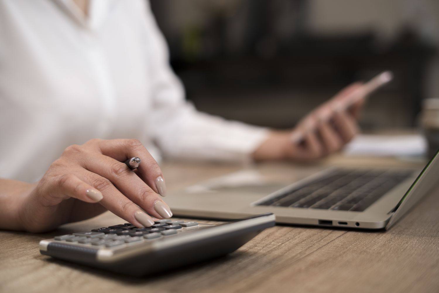 Woman's hand on calculator