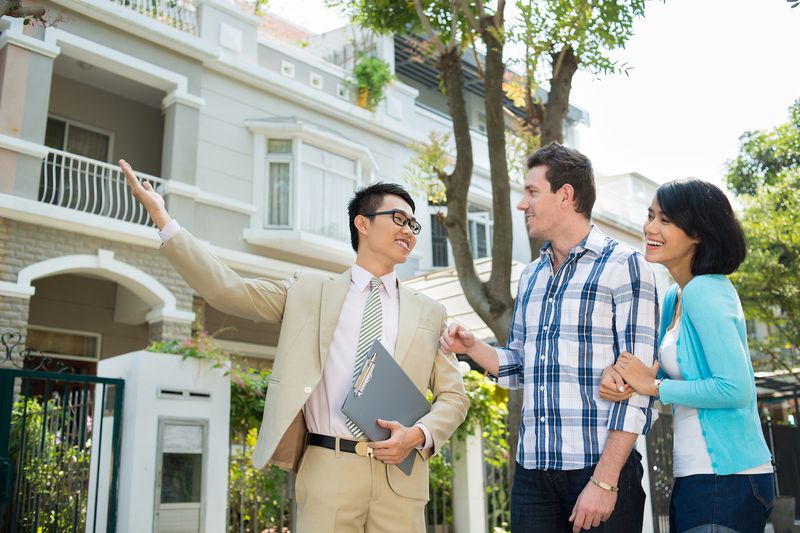 Real estate agent showing home to couple