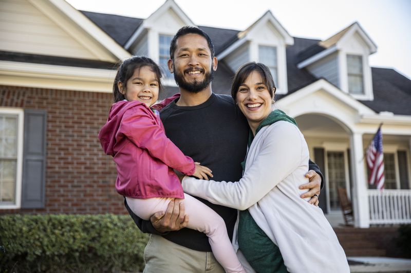 Portrait of a family in front of a suburban home