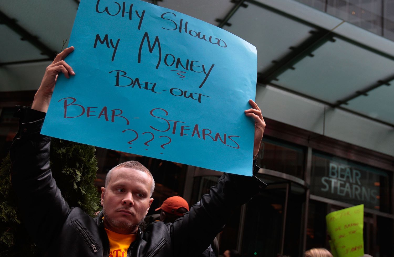 A protestor stands outside Bear Stearns headquarters March 26, 2008 in New York. Hundreds of housing activists stormed the lobby of the Bear Stearns skyscraper in Manhattan, overwhelming security and staging a noisy rally, protesting the government-backed sale and bailout of the investment bank. 