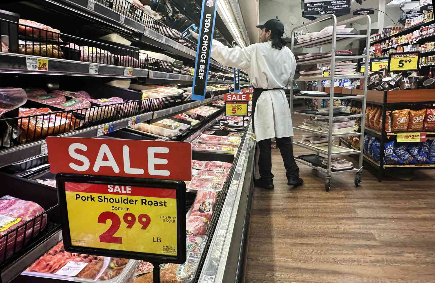 An employee restocks the shelves in the meat section of a supermarket in Monterey Park, California, on February 12, 2025. 