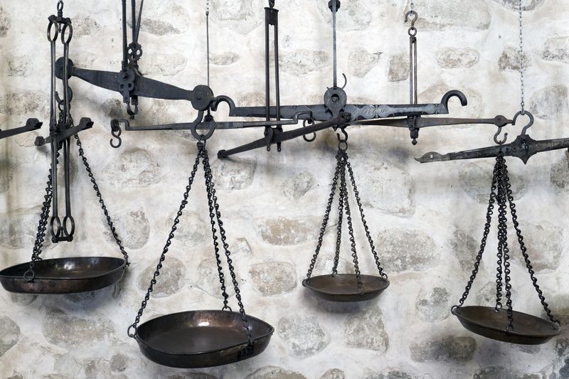 Old scales against a white washed stone wall in Potosi, Bolivia.