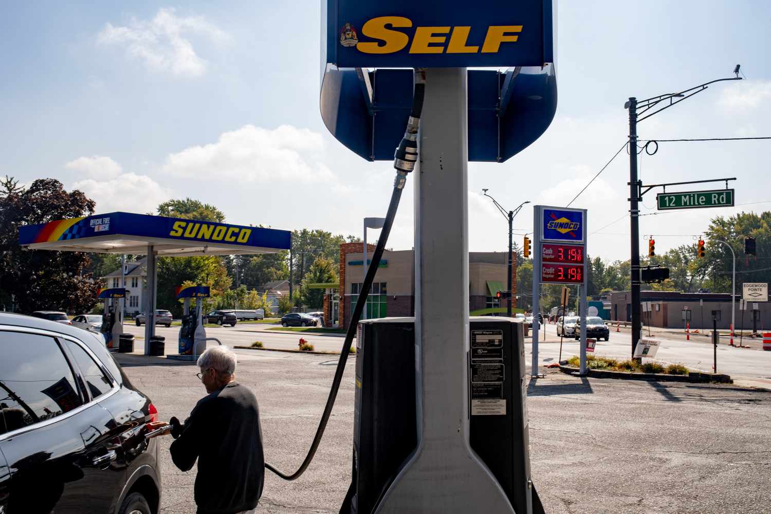 A driver refuels their vehicle at a Sunoco gas station in Royal Oak, Michigan, US, on Thursday, Sept. 19, 2024. 