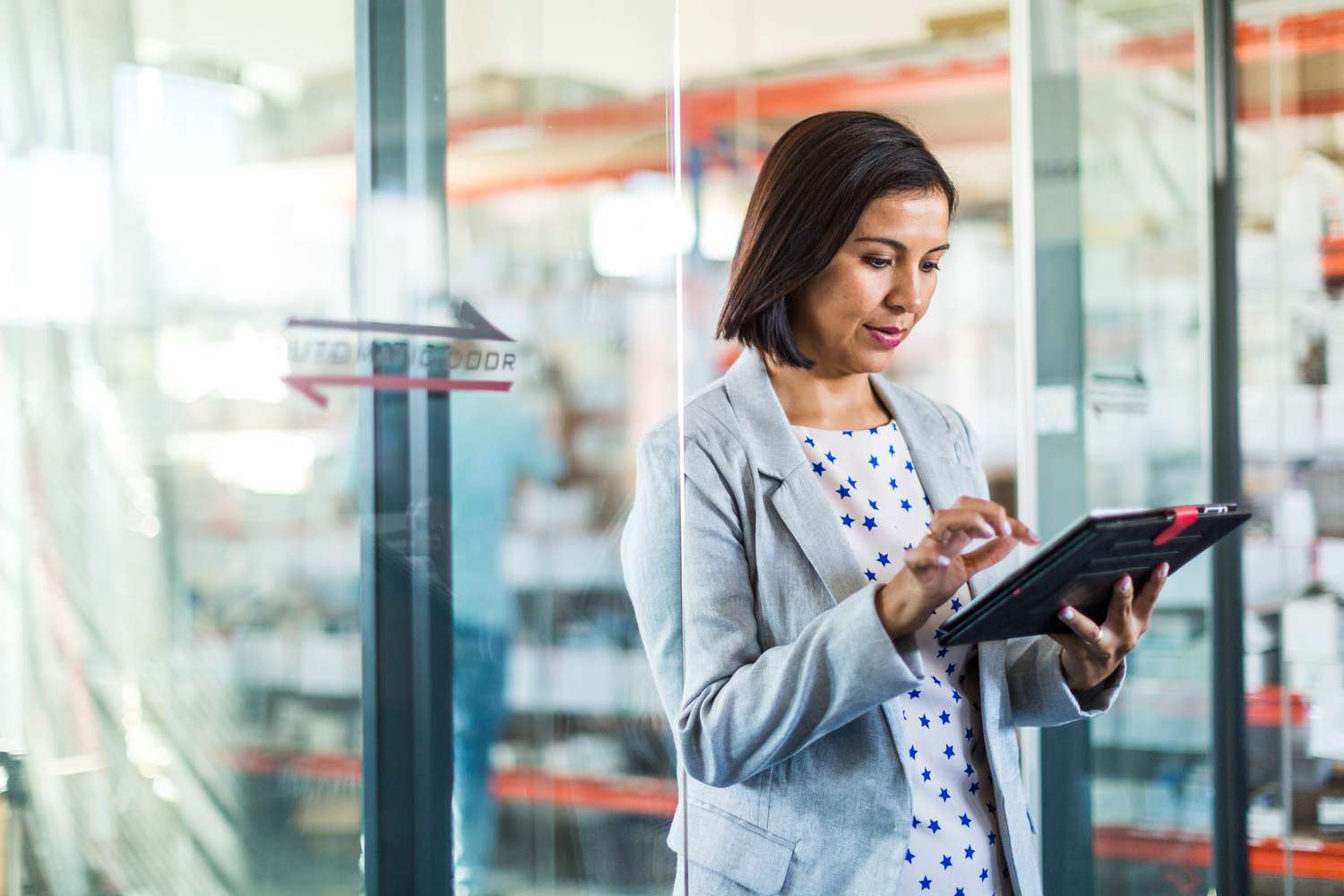 A business owner takes inventory using a tablet