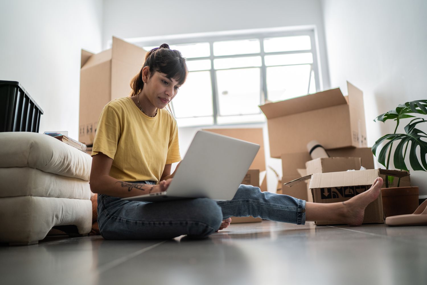 Woman checking on her relocation mortgage while preparing to move
