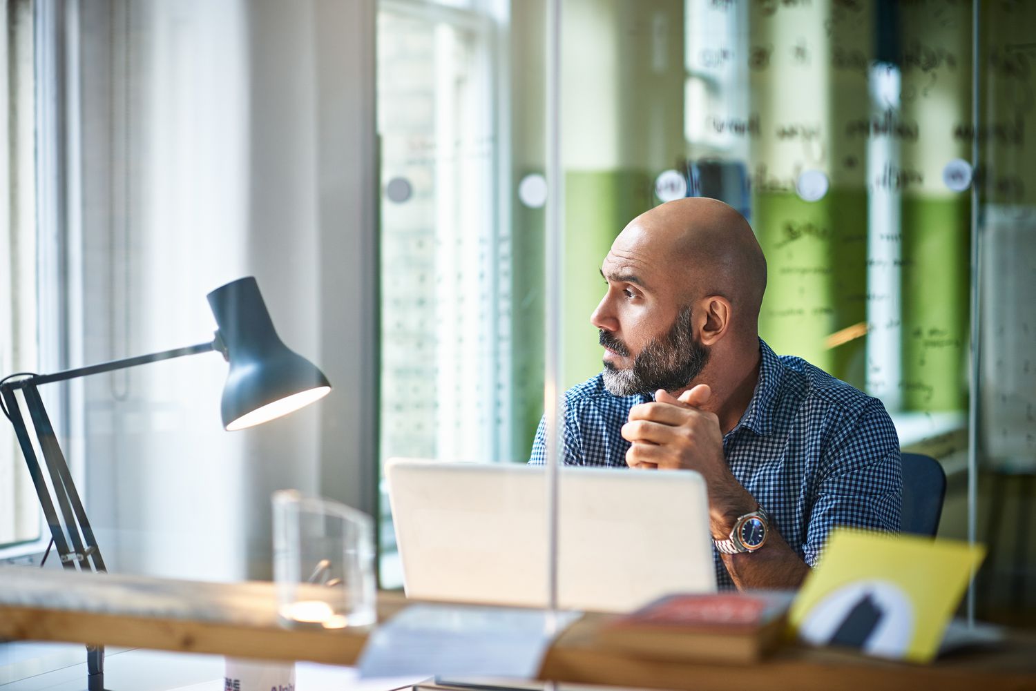A man looking out a window in an office