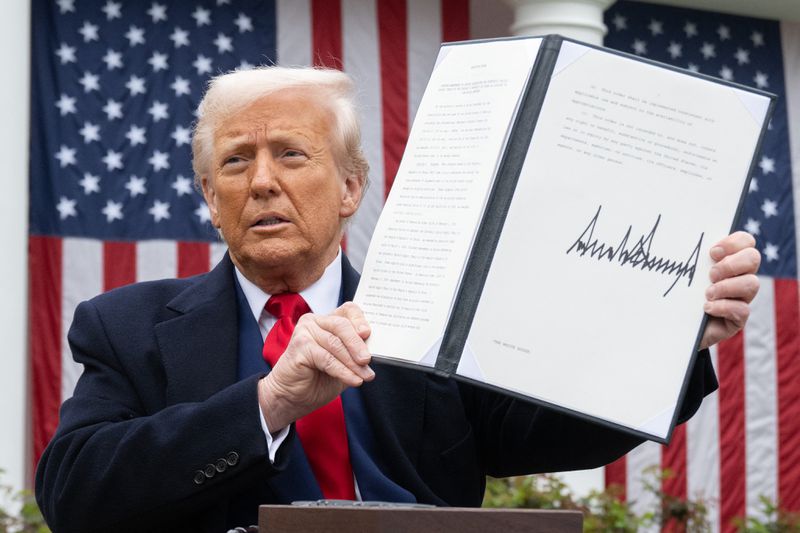 Donald Trump holding up a signed document