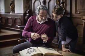 Grandfather showing stamp collection