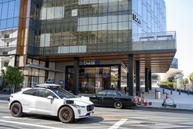 Waymo self-driving car parked in front of Uber headquarters building in San Francisco, California on Aug. 20, 2024.
