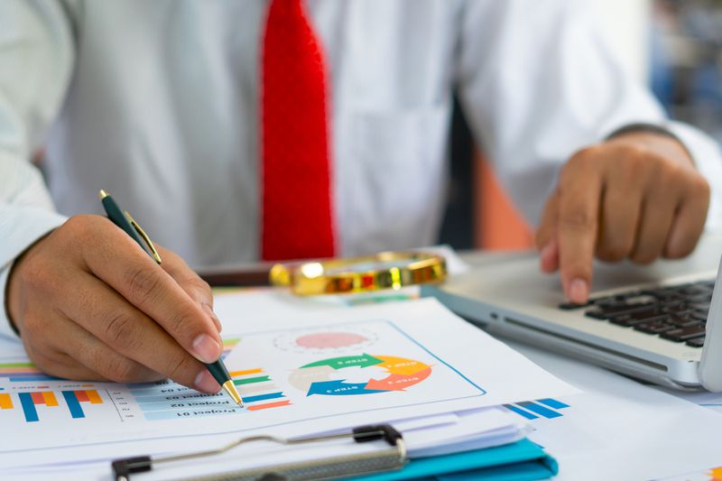 A businessman analyzing investment charts.