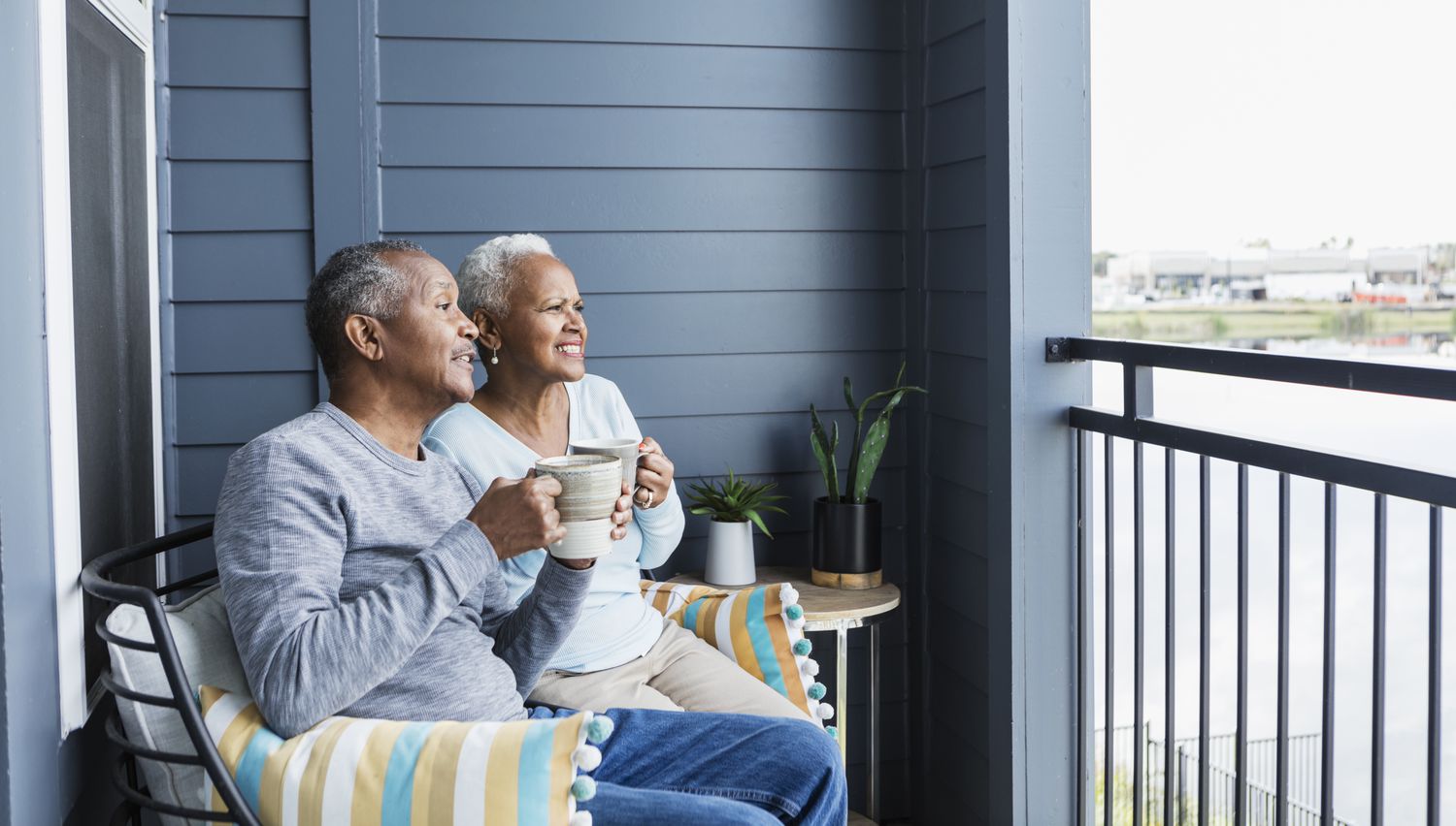 Senior couple relaxing outside on balcony