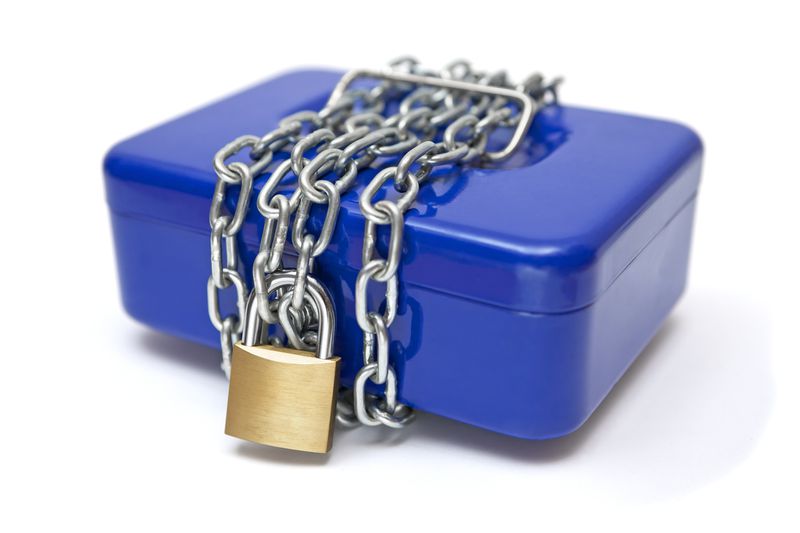 A lock-box wrapped in chains with a padlock