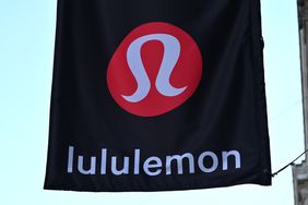 The red Lululemon logo is seen on a black banner outside a store.