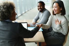 Couple with an agent at a table